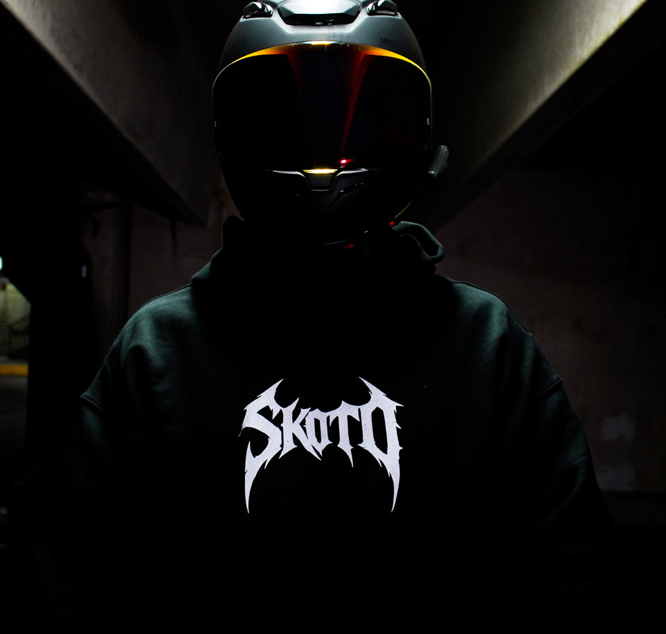 Black AUXESIS hoodie with the white Skoto chest mark.